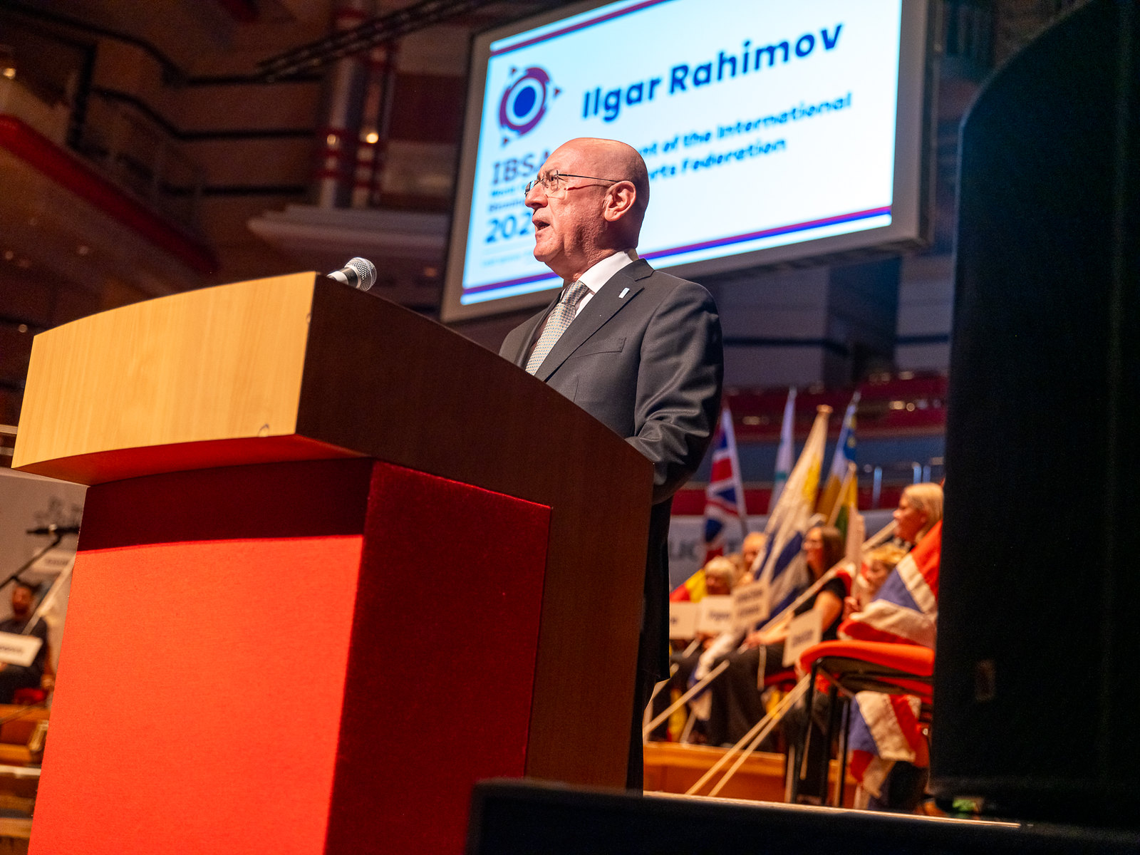 IBSA President Ilgar Rahimov stands at the lecturn to deliver his speech during the Opening Ceremony of the IBSA World Games in 2023